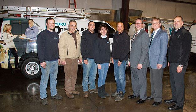 Officials from Hydrodynamics pose inside the company’s new building with representatives