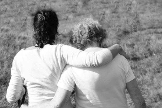 two women crying and hugging each other